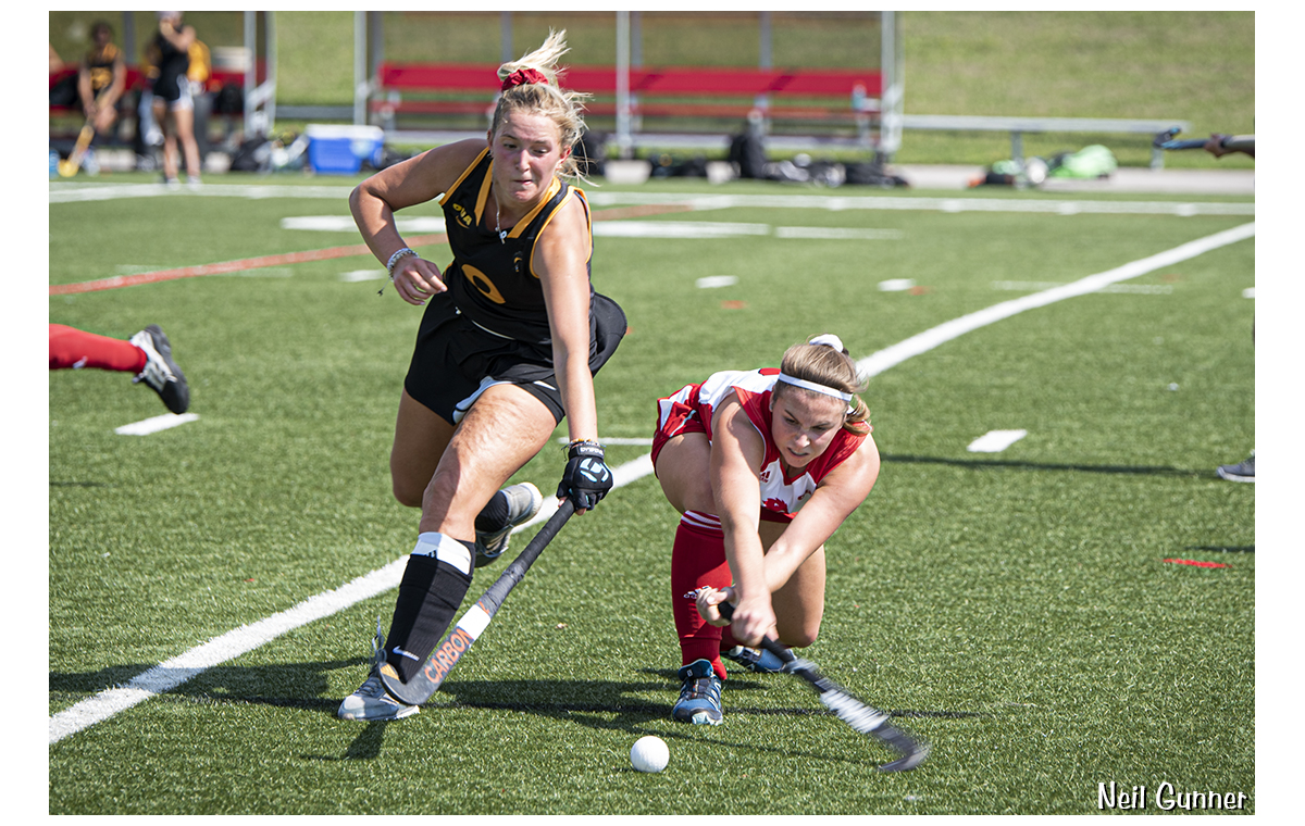 Field hockey players fight for the ball